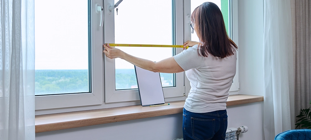 girl measuring window size