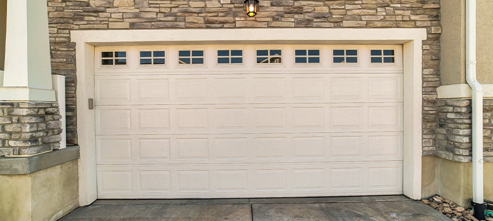 focus on the wide white panelled wooden door with glass panes of a townhouse