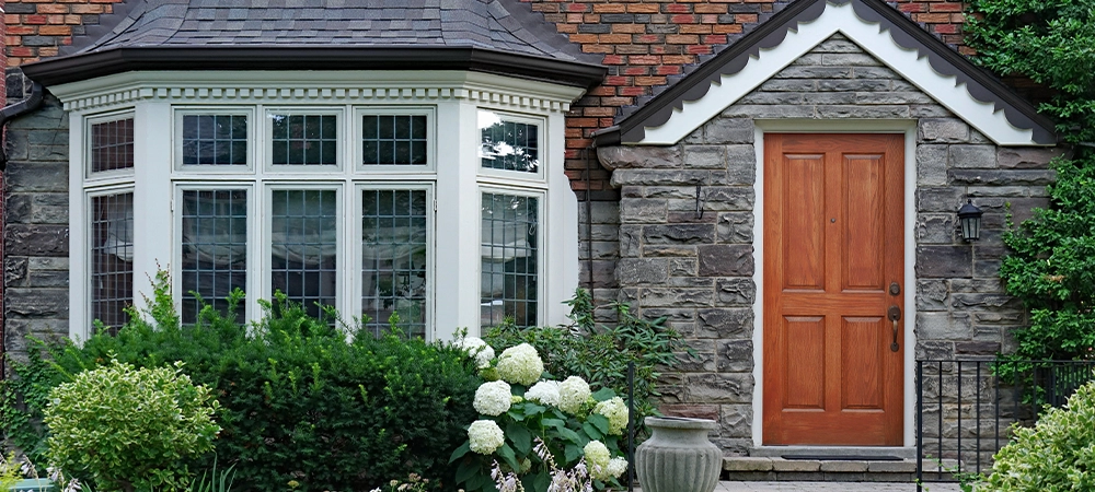 front garden of house with bay window and leaded glass